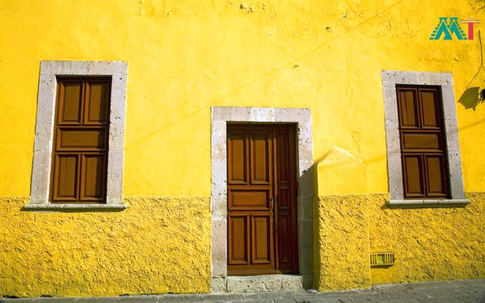 Yellow Adobe House Brown Doors In Morelia Mexico